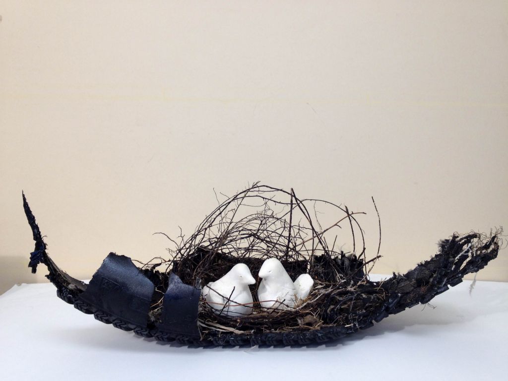 Dove Song, mixed media, tire piece, sticks, string, hair, feathers, clay, 7"H x 20"W x 7"D